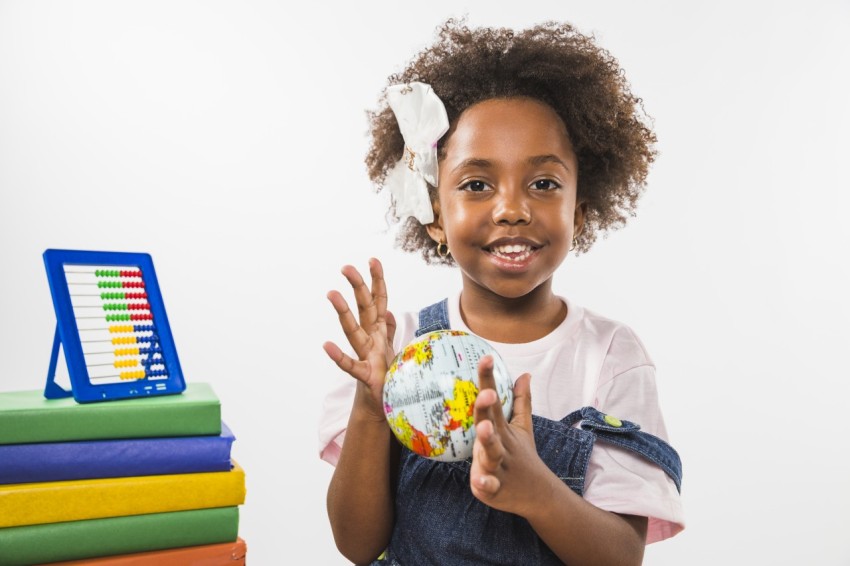 Child playing with globe studio