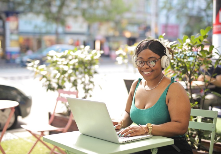 Young woman sitting cafe with computer